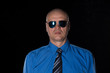 © serikbaib - portrait of a bald man in a blue shirt