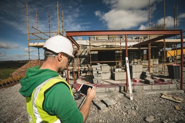Engineer using digital tablet at the construction site