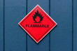Red diamond shape flammable warning sign on a blue door