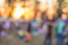 Unfocused Blurred Bokeh Festival Space With People In Bright Colorful Sunset Orange Time