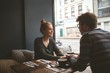 © Wavebreak Media - Couple holding hands in the cafe