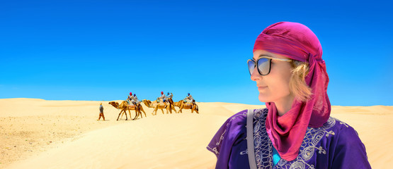 Close-up portrait of young woman in arabic traditional clothing. Sahara desert. Tunisia, North Africa