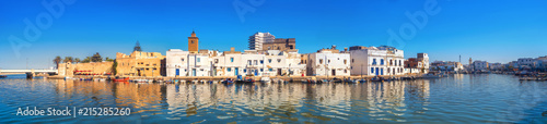 Fotomural Waterfront panorama with picturesque houses and wall of kasbah at old port in Bizerte