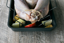 Thanksgiving: Raw Turkey In Pan With Aromatics And Apples With O