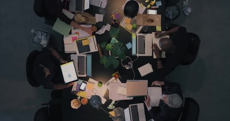 Wall Mural - top view diverse business people working late planning strategy for corporate project developing creative ideas in messy boardroom