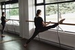 © Wavebreak Media - Young woman stretching on the barre