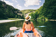© Micky Wiswedel/Stocksy - paddler in a canoe on a river in a lush green valley