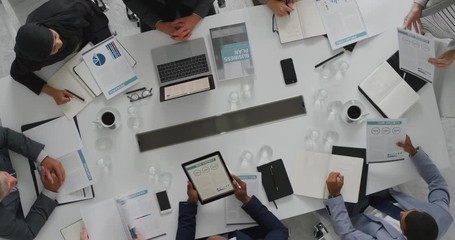 Wall Mural - professional business people meeting in boardroom diverse corporate leaders collaborating sharing ideas planning development strategy using tablet pc overhead