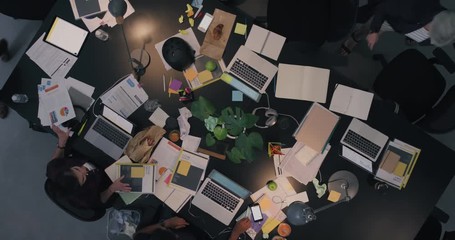 Wall Mural - happy business woman celebrating success sharing successful idea with colleagues in multi ethnic office executive team in messy boardroom top view