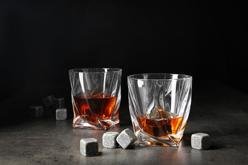 Glasses with liquor and whiskey stones on table