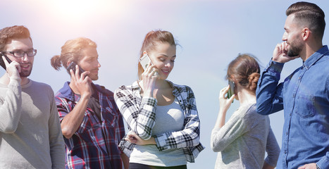 Wall Mural - young people talking on their smartphones.