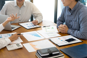 Wall Mural - Group of teamwork businessman and woman in the meeting work to analysis marketing data concept business discussion