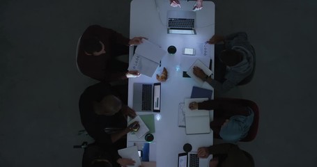 Wall Mural - senior business woman presenting corporate plan to colleagues in management meeting using projector technology professional female executive sharing market research data top view