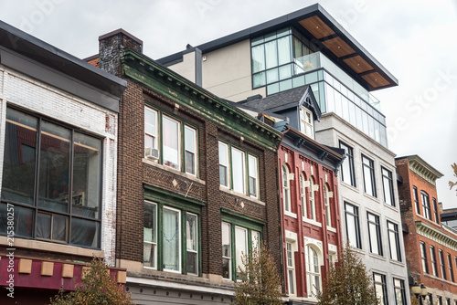 Cuadros en Lienzo Renovated Residential Building between a Row of Old Brick Buildings in Hamilton, ON, Canada, on a Cloudy Autumn Day