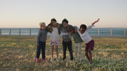 happy cheerful kids portrait of excited children group embracing celebrating enjoying seaside beach 