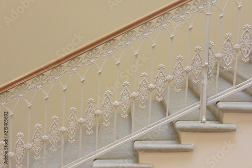 Staircase With White Ornamental Hand Railing In Historic