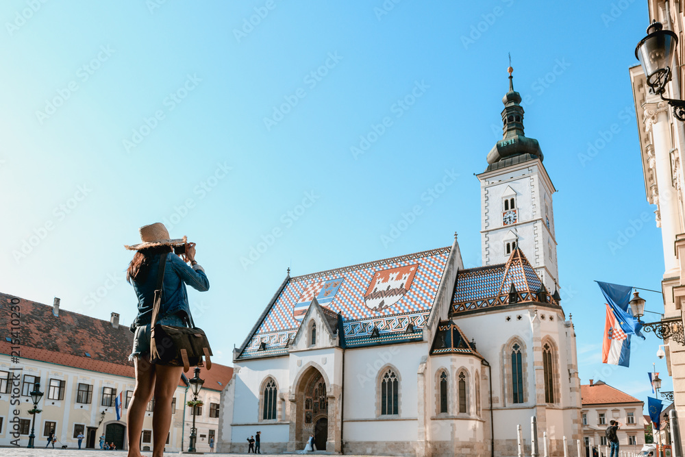 Obraz na płótnie Concept picture of travel in Croatia, women is taking picture St. Mark's Church in Zagreb w salonie