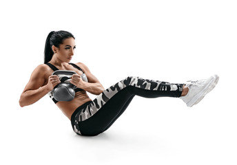 Muscular woman doing sit up exercise with kettlebell, abs. Photo of attractive latin woman in silhouette on white background. Strength and motivation