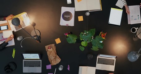 Wall Mural - top view diverse business people in modern boardroom working late interacting planning ambitious market strategy for developing company time lapse close up track