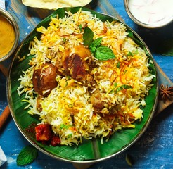 Homemade Chicken Biryani on banana leaf overhead view