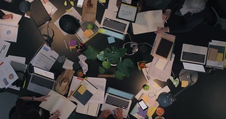 Wall Mural - top view diverse business team working late brainstorming planning strategy for corporate project developing creative ideas in messy boardroom