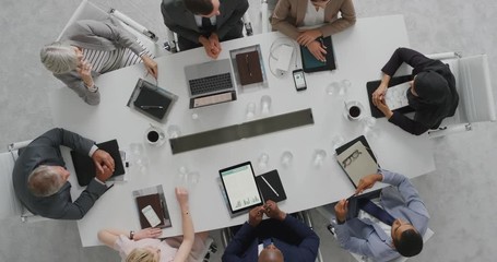 Wall Mural - diverse business people meeting in boardroom corporate leaders collaborating sharing ideas discussing project brainstorming successful strategy top view