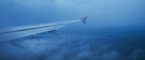 banner for website, View of jet plane wing with cloud patterns in the fog