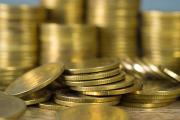 Columns of gold coins, piles of coins on working table, business banking and financial concept.