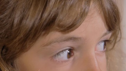 the eyes of a cute little girl looking around, close-up shot.