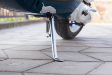 Silver Leg Of A Blue Moped