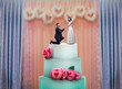 Wedding cake with bride and groom statuettes