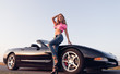 © jetrel2 - Sexy alluring young girl dressed in jeans and topic standing at car (cabriolet). Outdoor portrait on the road at sunset