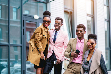 Wall Mural - peasant stylish business couples standing next to the office building. team and friendship concept