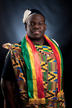 An African Man Is In National Cloth Pose And Smile On Gray Background