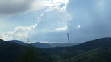 Fototapeta Tęcza - Chmury nad górami