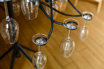 Wall Mural - Glass glasses hanging above the bar rack