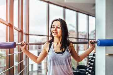 Wall Mural - Happy cute sporty girl workout in the gym