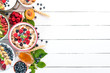 © Yaruniv-Studio - Large Assortment of porridge with fruit and berries. Breakfast. On a white wooden background. Top view. Free space for text.