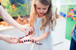 children touch the snake at the zoo