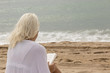 © SircPhoto - pretty blonde girl reading on beach