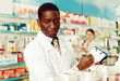 © JackF - Professional male pharmacist working at drugstore, checking medicines inventory with female colleague
