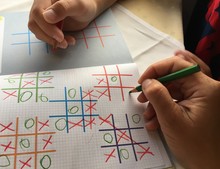 Mum And Kid Playing Tic Tac Toe In Travel 