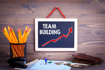 Wall Mural - Team Building. Business success concept. Chalkboard on a wooden background