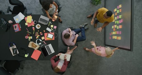 creative multi ethnic business people brainstorming startup business strategy making notes on colorful paper discussing ideas in office workplace collaborating teamwork