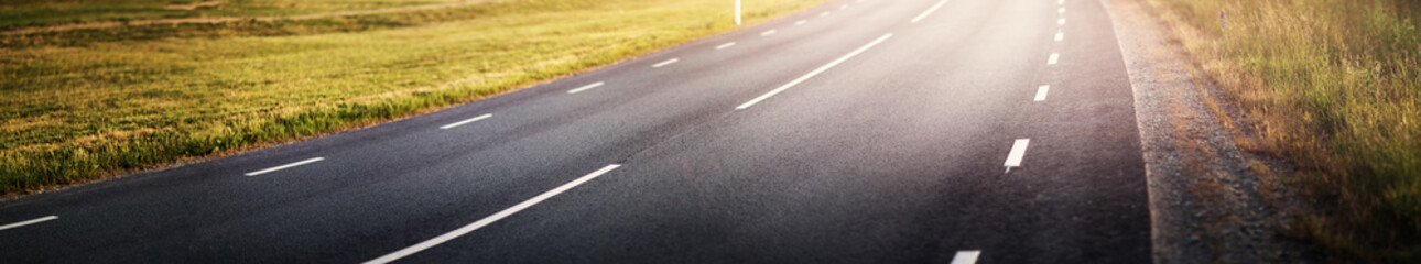 Canvas Print - black asphalt road and white dividing lines