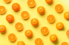 Fruit Pattern Of Fresh Orange Slices On Yellow Background. Top View. Copy Space. Pop Art Design, Creative Summer Concept. Half Of Citrus In Minimal Flat Lay Style.