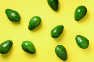 Wall Mural - avocado pattern on yellow background. top view. banner. pop art design, creative summer food concept