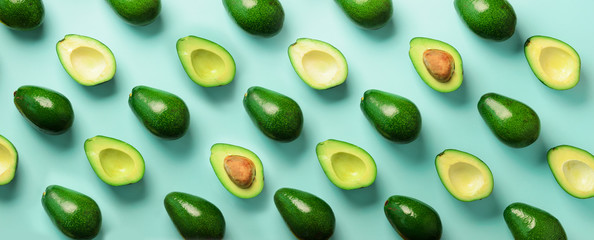 Wall Mural - avocado pattern on blue background. top view. banner. pop art design, creative summer food concept. 