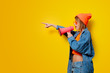 © Masson - Young style girl in jeans clothes with pink megaphone on yellow background. Symbolizes female resistance. Clothes in 1980s style