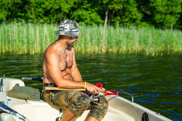 Wall Mural - man fishes in the lakes of the Mazury